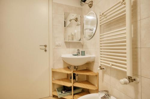 a bathroom with a sink and a toilet and a mirror at Linate Airport - Apt with Garden in Milan