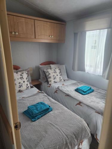 a bedroom with two beds with towels on them at 2 Vale Park in Fishguard