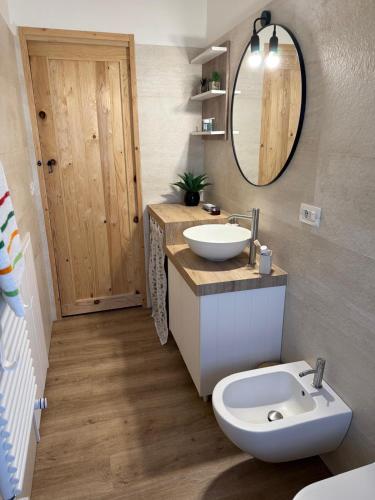a bathroom with a sink and a toilet and a mirror at Pepe Apartments Asy in Castellammare di Stabia