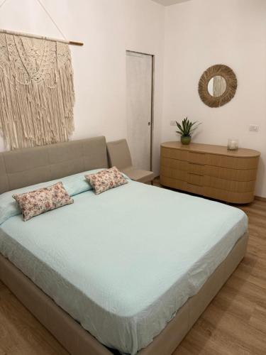 a bedroom with a large bed with two pillows at Pepe Apartments Asy in Castellammare di Stabia