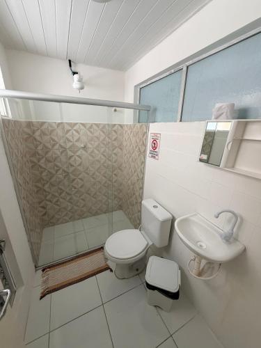 a bathroom with a toilet and a sink at Pousada Extensão Sabrinna in Maceió