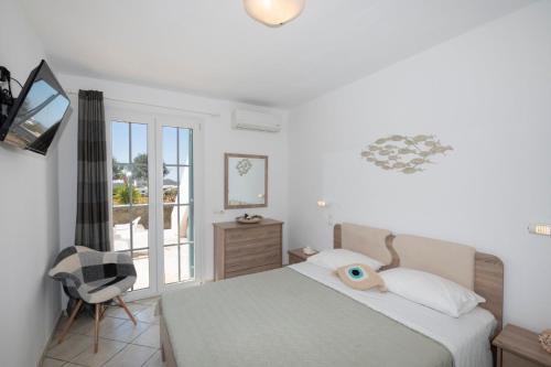a bedroom with a bed with a fish head on it at Sunset 7.59 in Mikonos