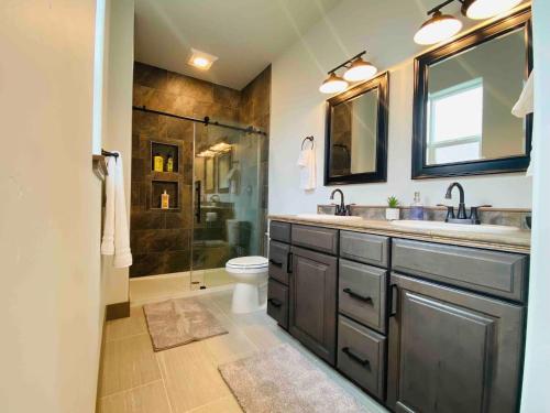 a bathroom with a sink and a toilet and a shower at Comfy 4 Bdrm House with Air Conditioning in Corvallis