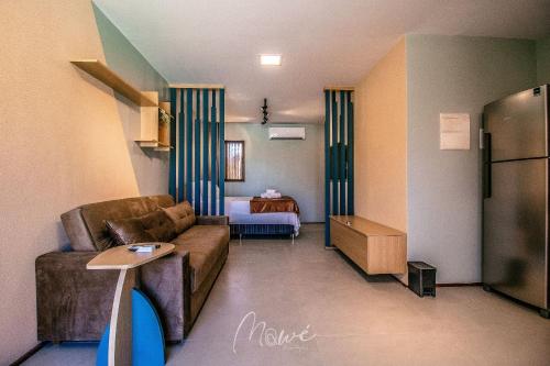 a living room with a couch and a room with a bed at Studio perfeito na Rota de Milagres in Pôrto de Pedras