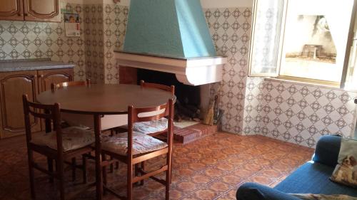 a dining room with a table and a fireplace at Casa Michele in Pau