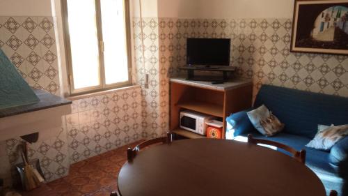 a living room with a table and a tv at Casa Michele in Pau