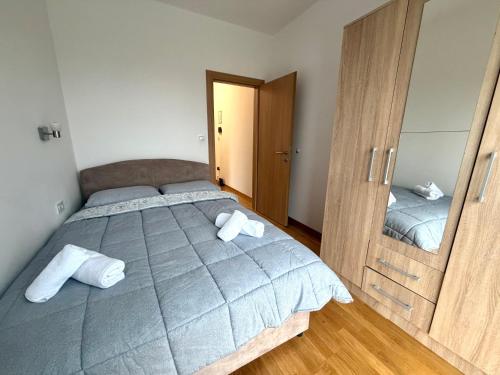 a bedroom with a large bed and a mirror at Zenith Apartment - Herceg Novi & Beach & Private Parking in Bijela