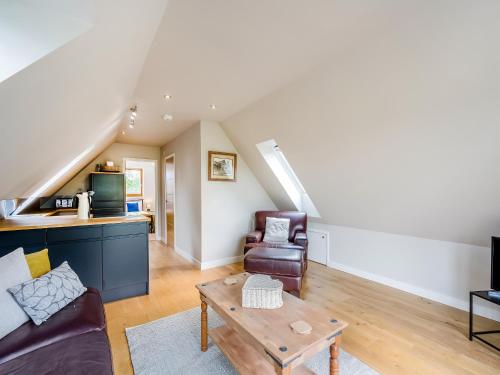 a living room with a couch and a table at Pond View Loft in Sudbury