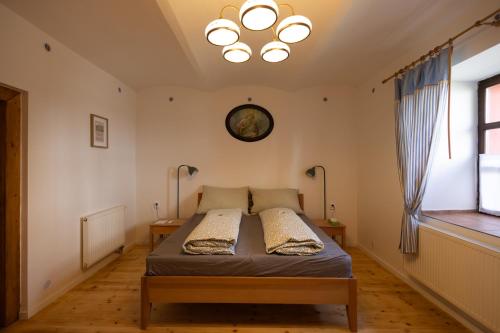 a bedroom with a bed and a clock on the wall at U Čertovy brázdy in Sázava