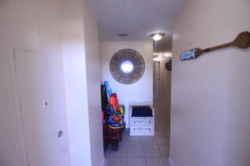 a hallway with a room with a mirror and a door at Sunsets and Palms in Gulf Shores