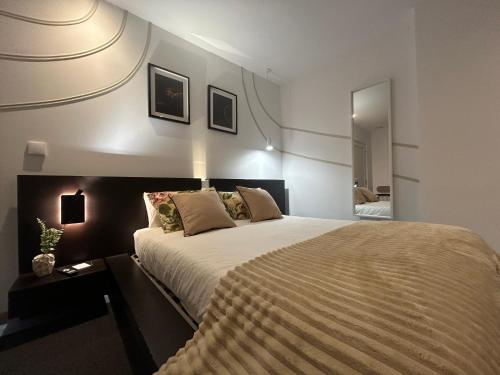 a bedroom with a large bed in a room at Bela vista AL in Paredes de Coura