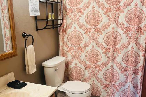 a bathroom with a toilet and a shower curtain at Happy Jack in Rapid City
