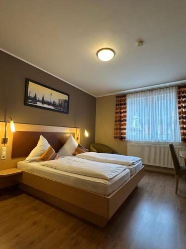 a bedroom with a large bed in a room at Hotel Löwen in Blaubeuren