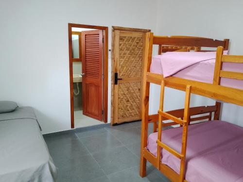 a room with two bunk beds and a doorway at Fifi Shouse Ayangue in Santa Elena