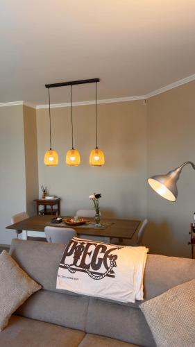 a living room with a couch and three lights at NB Luxury Attico Vista Mare in Sanremo