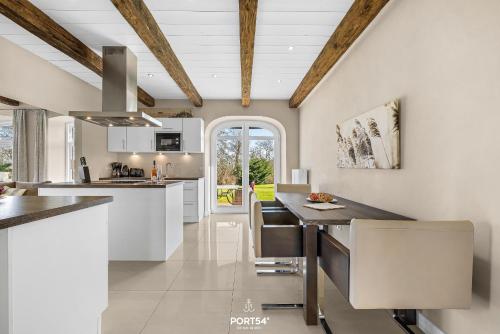 a kitchen with white cabinets and a large island at Ferienwohnung Lille Hus 1 St Peter-Ording in Böhl