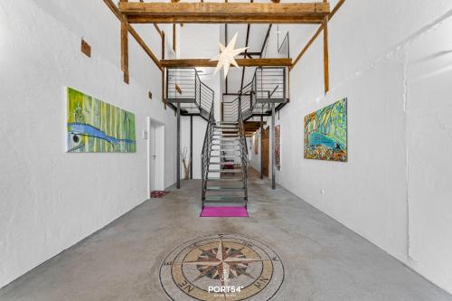a staircase in a room with paintings on the walls at Ferienwohnung Lille Hus 2 St Peter-Ording in Böhl