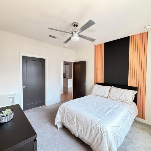 a bedroom with a bed and a ceiling fan at Luxury Downtown Houston Skyline Suite in Houston