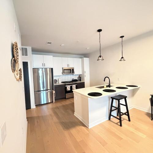 a kitchen with white cabinets and a counter top at Luxury Downtown Houston Skyline Suite in Houston