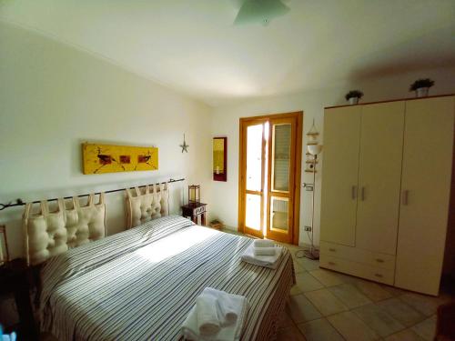 a bedroom with a large bed and a window at Residence Orsa Minore in Gallipoli