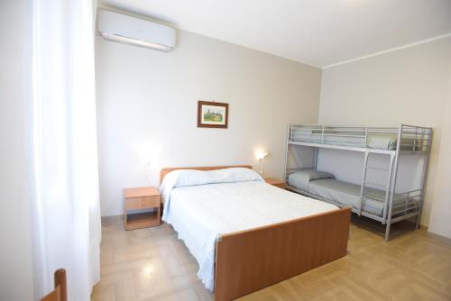 a bedroom with a bed and a bunk bed at Villa Erry in Trani