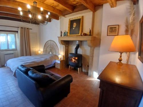 a living room with a bed and a fireplace at La Source de Romay 2 pers 5 min Paray in Volesvres