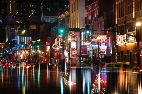 a busy city street at night with traffic at Motto By Hilton Nashville Downtown in Nashville