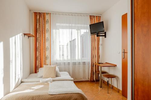 a hotel room with a bed and a window at Natural Mielno in Mielno