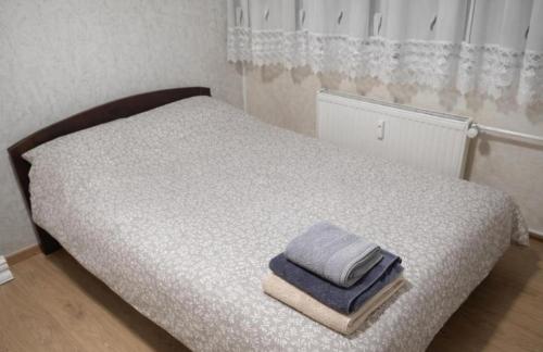 a bedroom with a bed with two towels on it at Apartman Centar 1 in Šabac