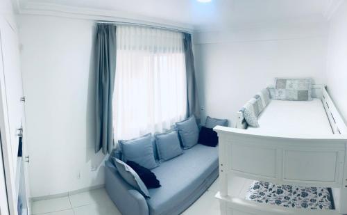 a blue couch in a room with a window at Sea & Pool View Apt 1 in Aourir