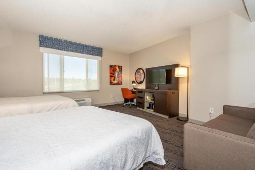 a hotel room with two beds and a flat screen tv at Hampton Inn & Suites Flagstaff - West in Flagstaff