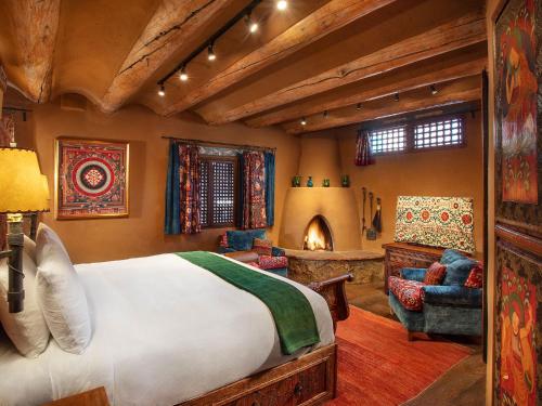 a bedroom with a bed and a living room at The Inn of Five Graces in Santa Fe
