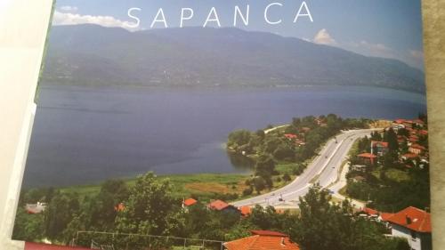 a book with a picture of a lake and a road at Eren Villa in Sapanca