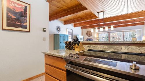 a kitchen with a stove and a counter top at Riverside Condos D01 by AvantStay Condo Close To Downtown Town Park Ski Lift 8 in Telluride