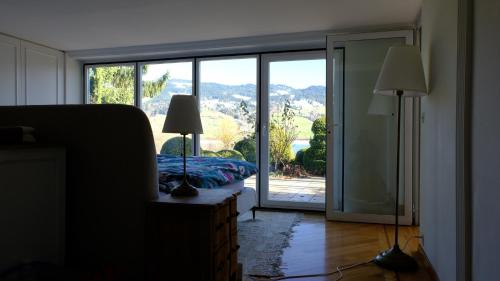 a bedroom with a bed and a sliding glass door at Rose Garden Switzerland in Avry devant Pont