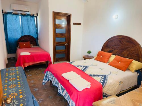 a room with two beds and a ladder in it at Hotel Yopez in Acapulco