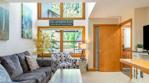 a living room with a couch and a table at Cimarron Lodge 14 by AvantStay Ski-InSki-Out Property in Complex w Two Hot Tubs Permit3601 in Telluride
