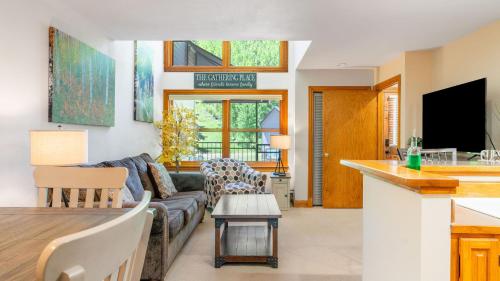 a living room with a couch and a table at Cimarron Lodge 14 by AvantStay Ski-InSki-Out Property in Complex w Two Hot Tubs Permit3601 in Telluride