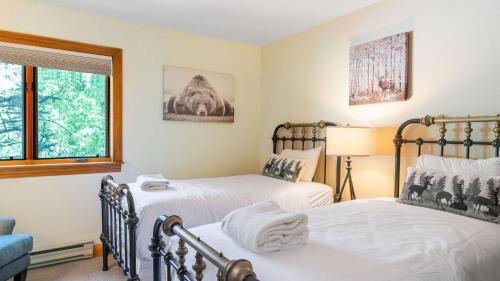a bedroom with two beds and a window at Cimarron Lodge 14 by AvantStay Ski-InSki-Out Property in Complex w Two Hot Tubs Permit3601 in Telluride