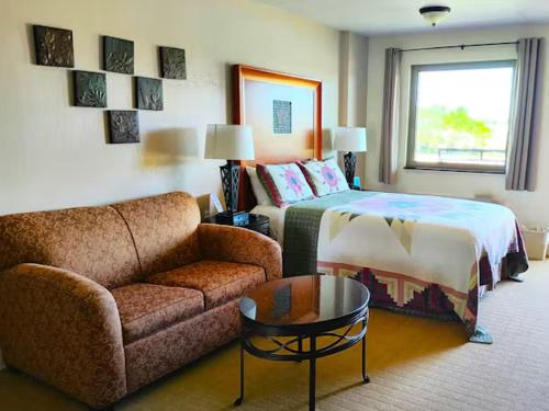 a bedroom with a couch and a bed and a couch and a table at The Lodge at Russell - Russell Inn in Russell