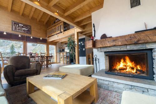 a living room with a fireplace in a house at Chalet Boder - Vue MontBlanc - Cheminée in Finhaut