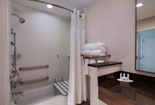 a bathroom with a shower and a toilet and a sink at Fairfield by Marriott Inn & Suites Waller in Waller