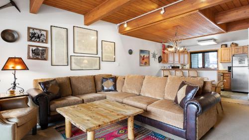 a living room with a couch and a table at Riverside Condos B101 by AvantStay Condo Close To Downtown Town Park Ski Lift 8 in Telluride