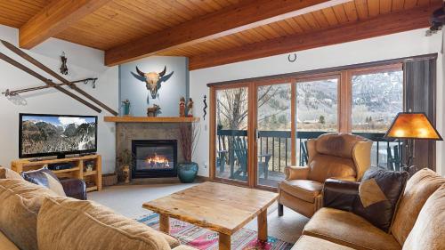 a living room filled with furniture and a fireplace at Riverside Condos B101 by AvantStay Condo Close To Downtown Town Park Ski Lift 8 in Telluride