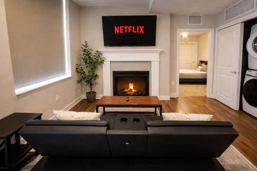 a living room with a couch and a fireplace at Cozy Downtown Suite Stadiums, Casino, R&R HoF in Cleveland