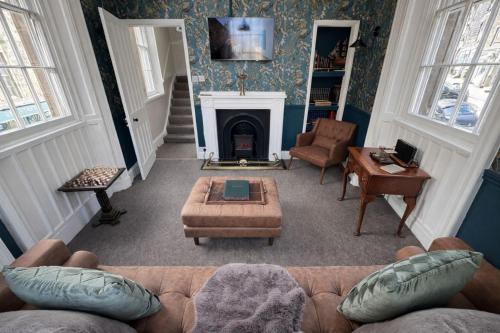 a living room with a couch and a fireplace at The Counting House in Alnwick