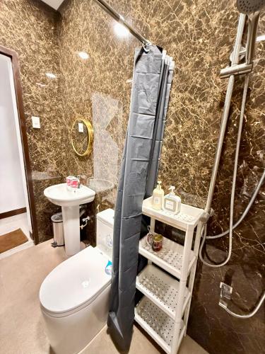 a bathroom with a toilet and a shower at Log Cabin Tagaytay in Tagaytay
