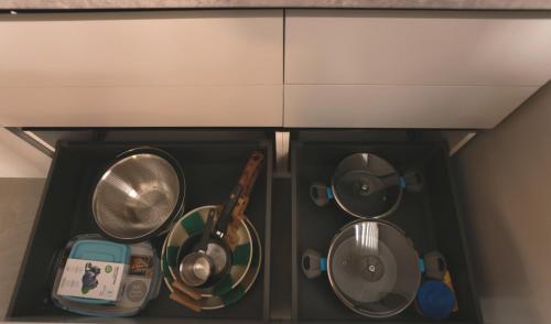 a drawer filled with pots and pans in a kitchen at TelMar Kiti Escape House in Kiti