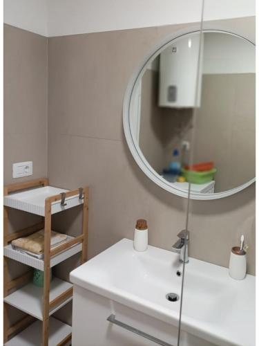 a bathroom with a sink and a mirror at Casa Mia 2 in Punat