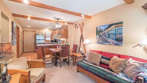 a living room with a couch and a kitchen at Ghostriders 5 by AvantStay 2 Bedroom Condo Near Main Street Hiking Skiing STR permit 3571 in Telluride